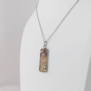 PXL_20261013_184422067PORTRAITORIGINAL - Blue Pendulum Jewelries Silver chain necklace with a rectangular marbled pendant resting against a white background.